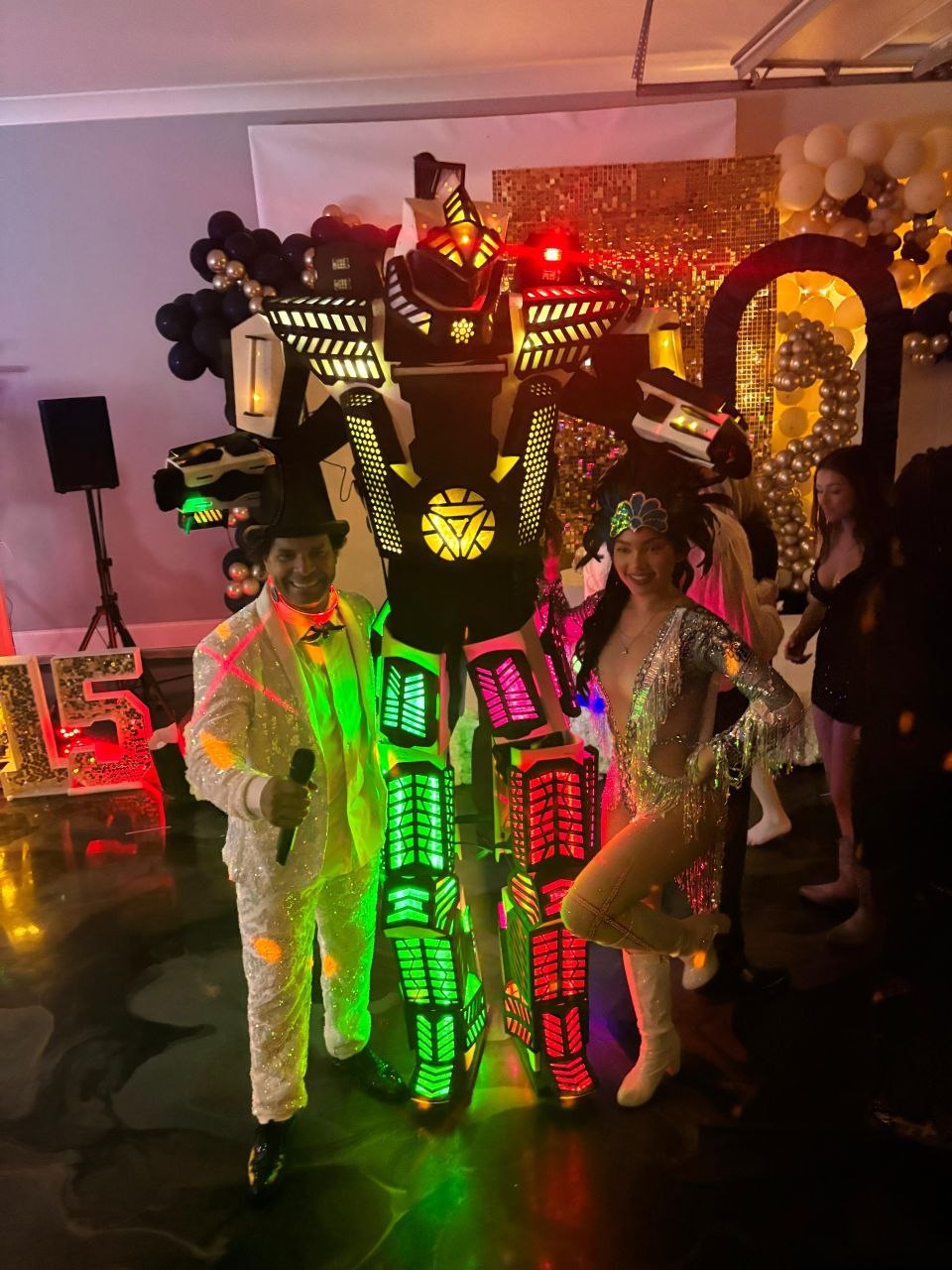 8FT LED Robot posing with MC and dancer under gold lighting
